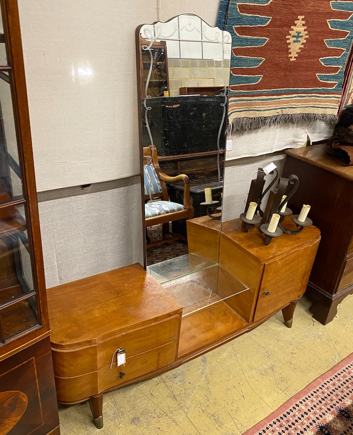 A 1960's mahogany mirrored dressing table, width 150cm, depth 38cm, height 154cm